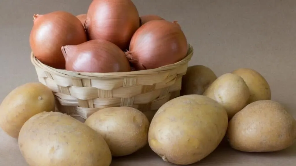 Where should onions and potatoes be stored