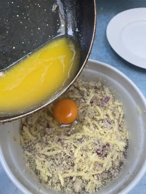 adding egg to bind stuffed mushroom ingredients